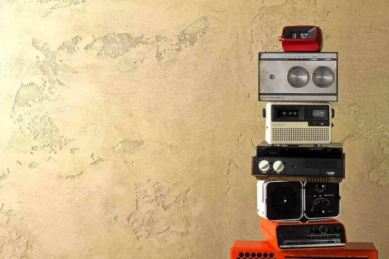 Textured Venetian Plaster Wall with a stack of vintage radios