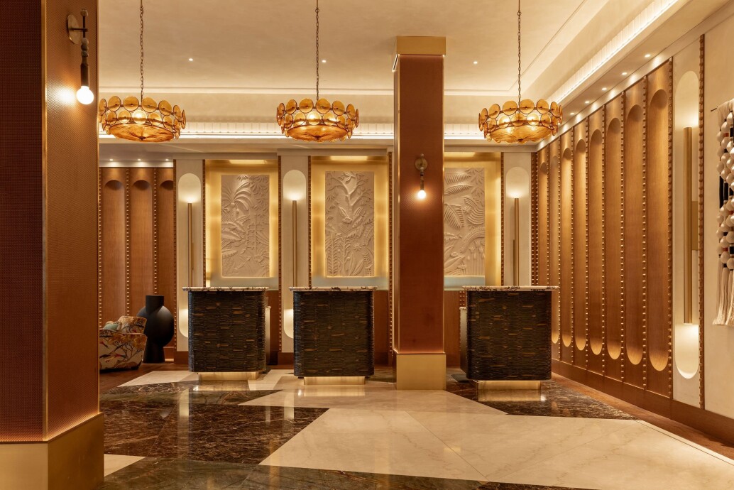 Reception area at The Trafalgar St. James showcasing Viero UK’s hand-finished plaster walls, decorative lighting, and marble flooring with modern ar